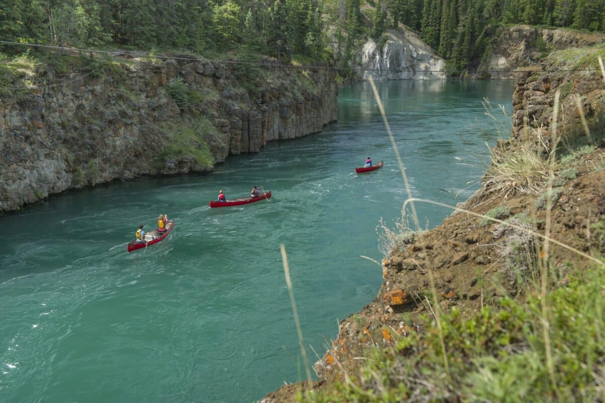 https://www.discovercanadatours.com/wp-content/uploads/2022/05/canoeingMilescanyon-39517-scaled-e1657211593123.jpg