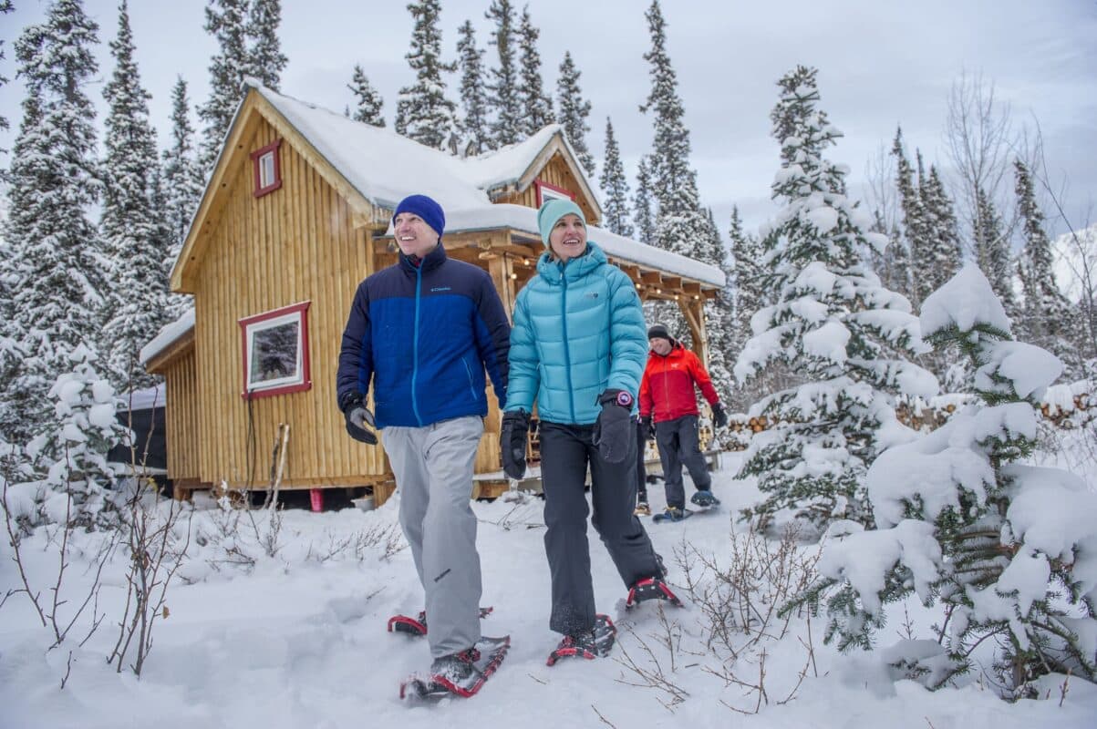 https://www.discovercanadatours.com/wp-content/uploads/2022/05/snowshoesandcabin-32519-scaled-e1657221299473.jpg