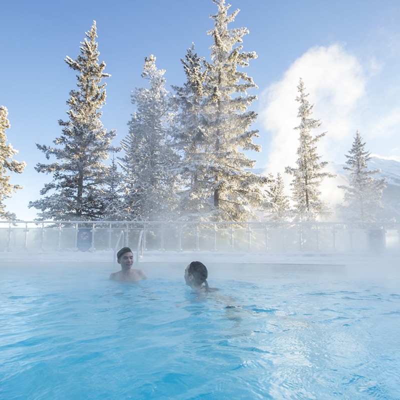 https://www.discovercanadatours.com/wp-content/uploads/2022/06/Winter_Banff_Upper_Hot_Springs_2016_Noel_Hendrickson_Pursuit_BanffJasperCollection.jpg