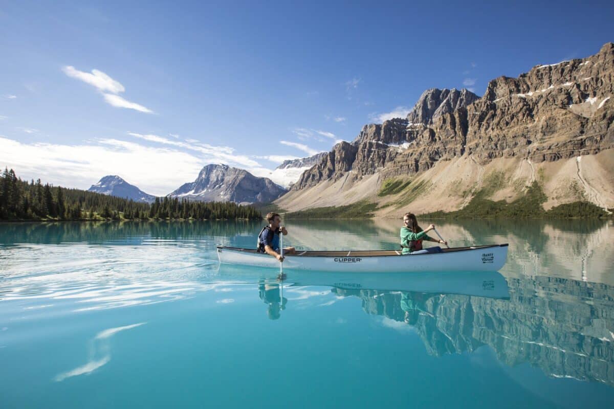 https://www.discovercanadatours.com/wp-content/uploads/2022/07/Canoeing_Bow_Lake_Noel_Hendrickson_2_Pursuit_BanffJasperCollection-1-e1659038673788.jpg