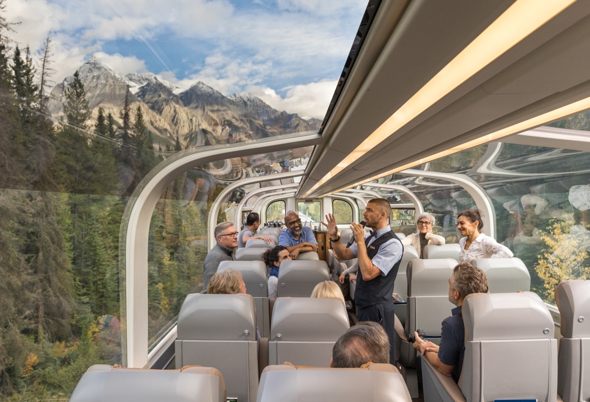https://www.discovercanadatours.com/wp-content/uploads/2023/05/RM18_Onboard_GoldLeaf_Service_Host©Rocky-Mountaineer_72-1.jpg