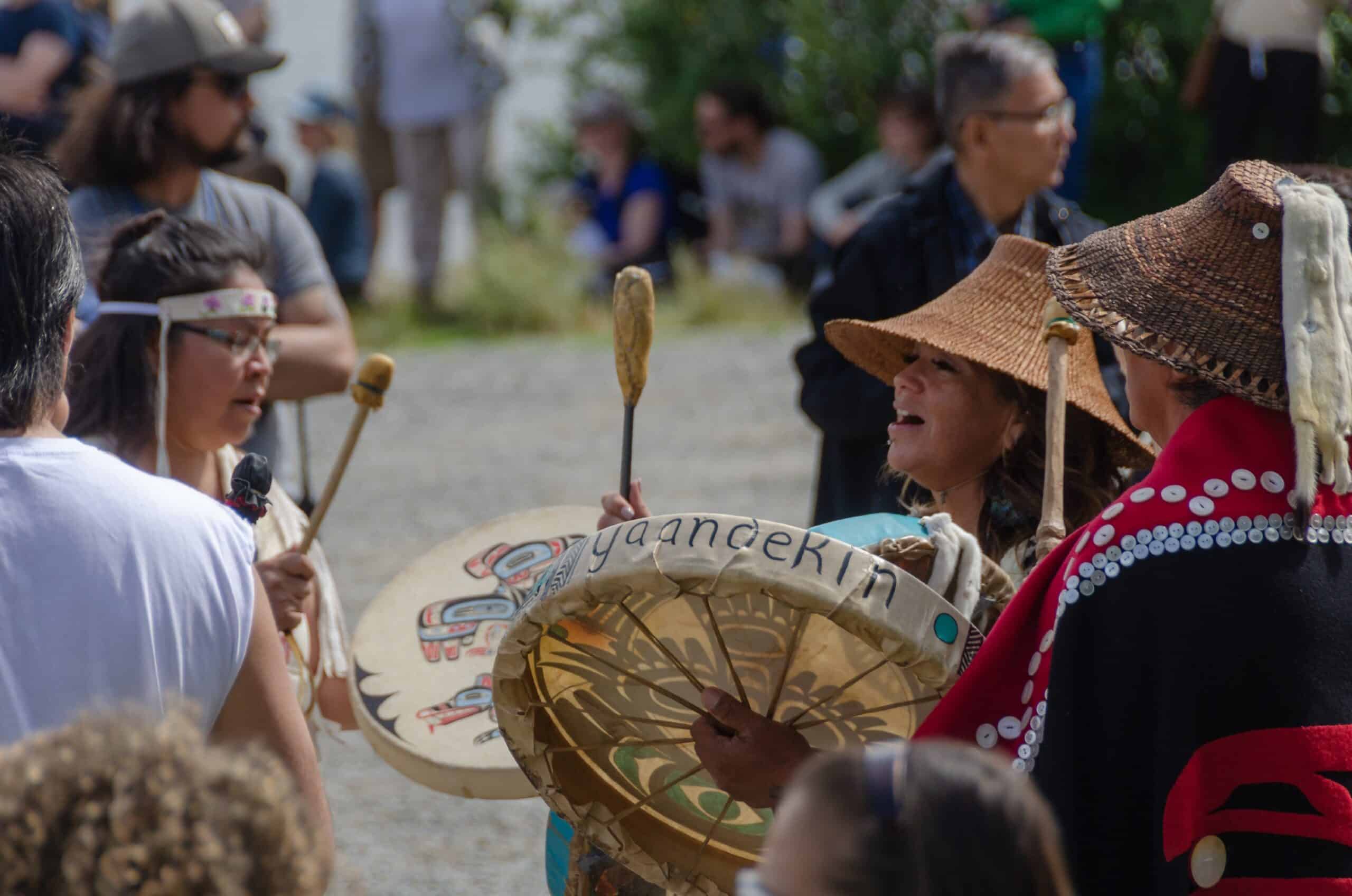 https://www.discovercanadatours.com/wp-content/uploads/2023/06/©-Government-of-Yukon_The_boat_launch_processio_and_ceremony_for_the-AdakaCanada-150-boat-builders-scaled.jpg